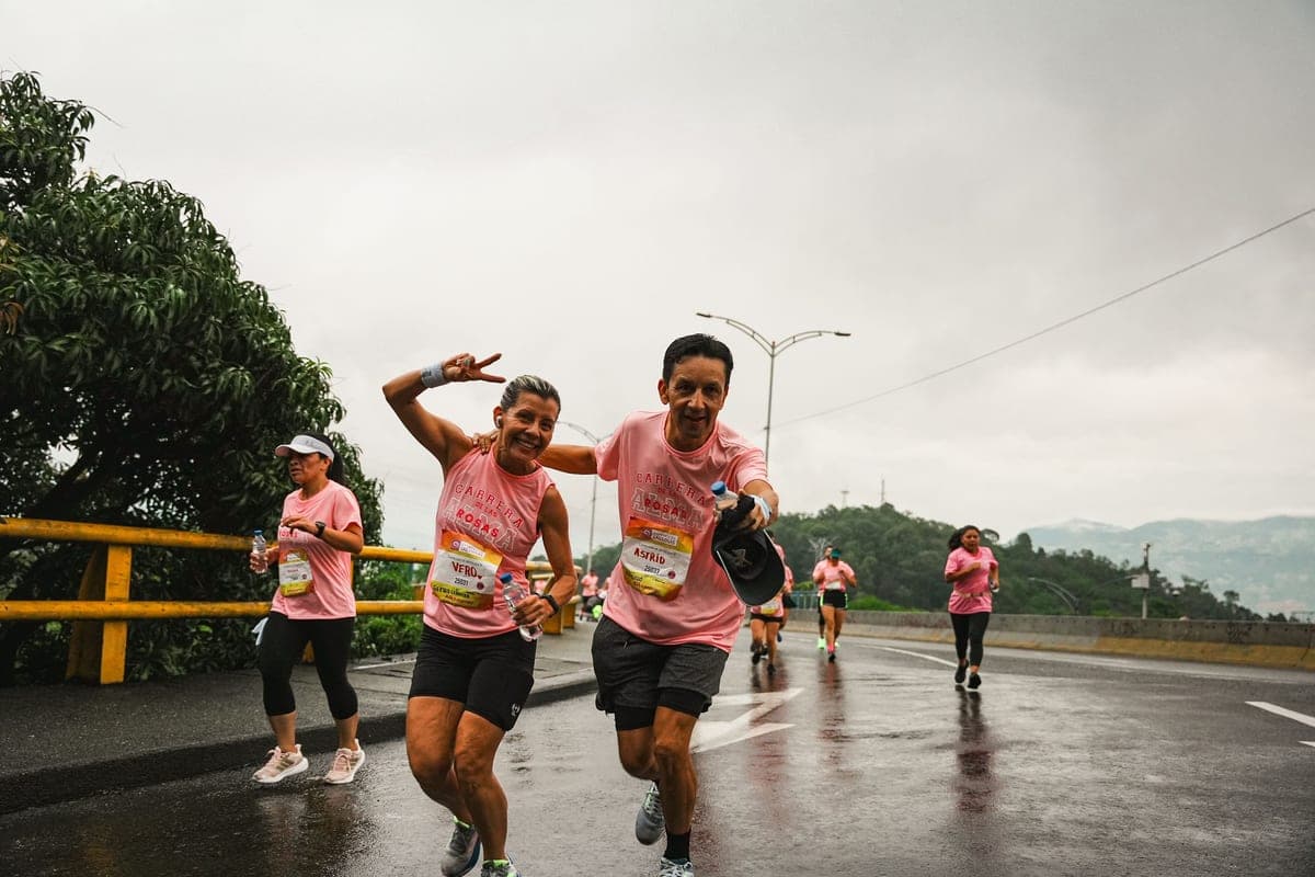 Smiling runners in a road race on a rainy day
